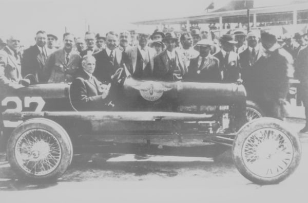 Louis Chevrolet stands proudly behind Henry Ford as he tries out one of his Fronty-Ford